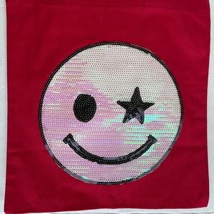 Red tote bag with iridescent smiley face